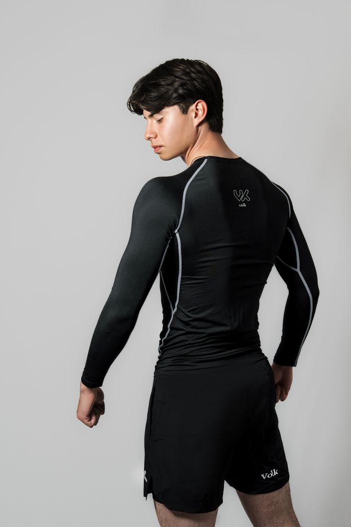 ours-journey Athletic young man in black sportswear, poised and confident, showcasing fitness apparel.
